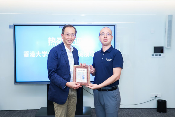 Exchange of souvenirs between Professor William K.M. Lee, Director, and Mr Yun Pan, Marketing Director, Midea Cloud of Midea Group
